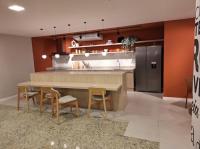 a kitchen with a counter with chairs and a table at Flat Casa Mauá in Rio de Janeiro