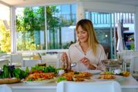 een vrouw die eten eet aan een tafel met borden eten bij Chiangkhan River Mountain Resort in Chiang Khan