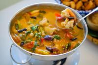 een kom soep met een lepel erin bij Chiangkhan River Mountain Resort in Chiang Khan