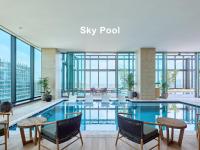 a hotel lobby with a swimming pool and windows at Mitsui Garden Hotel Yokohama Minatomirai Premier in Yokohama