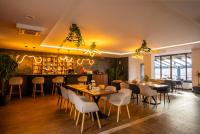 a restaurant with tables and chairs and a bar at Hotel TURRIS in Turnu Măgurele