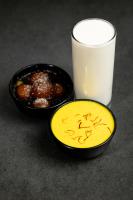 two bowls of food and a glass of milk at Dreamliner Hotel in Addis Ababa