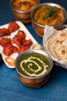 a table with bowls of dip and a plate of food at Dreamliner Hotel in Addis Ababa