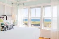a bedroom with a bed with a view of the ocean at Ocean House Boutique Hotel & Motel in Old Orchard Beach