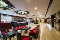 a restaurant with tables and chairs and a bar at Atami Hotel in Taipei