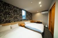 TRIGON Hotel FUKUOKAにあるベッド