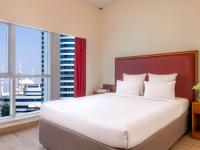 Postel nebo postele na pokoji v ubytování Aparthotel Adagio Fujairah