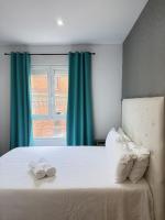 A bed or beds in a room at Apartamentos Day Madrid ILDEFONSO Centro Gran Via Sol Malasaña