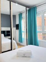A bed or beds in a room at Apartamentos Day Madrid ILDEFONSO Centro Gran Via Sol Malasaña