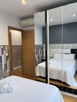 A bed or beds in a room at Apartamentos Day Madrid ILDEFONSO Centro Gran Via Sol Malasaña