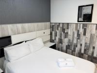 A bed or beds in a room at Apartamentos Day Madrid ILDEFONSO Centro Gran Via Sol Malasaña