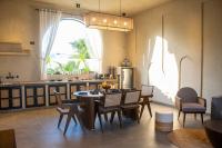 a kitchen and dining room with a table and chairs at Rawstone Luxury Villas Jaipur in Jaipur