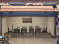 a dining room with a long table and chairs at Eastin Dè Royalè in Hyderabad