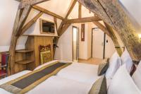 a bed in a room with wooden beams at Hotel Agora Brussels Grand Place in Brussels