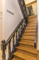 a staircase with black railings and wood treads at Hotel Agora Brussels Grand Place in Brussels