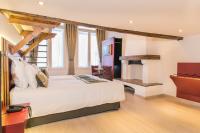 a hotel room with a bed and a fireplace at Hotel Agora Brussels Grand Place in Brussels