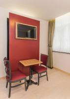 a table and two chairs in a room at Hotel Agora Brussels Grand Place in Brussels