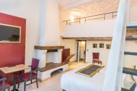 a bedroom with a loft bed and a desk and chairs at Hotel Agora Brussels Grand Place in Brussels