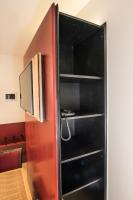 a black bookcase with a television in a room at Hotel Agora Brussels Grand Place in Brussels