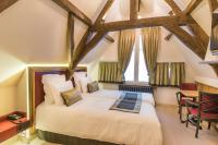 a bedroom with a bed and a table and chairs at Hotel Agora Brussels Grand Place in Brussels