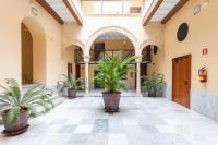 a hallway with potted plants in a building at Casa Singular , parking gratis in Jerez de la Frontera