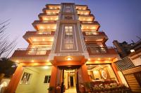 a large building with a tall tower with lights on it at Hotel Sherpani in Kathmandu