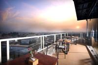a balcony with tables and chairs on top of a building at Hotel Sherpani in Kathmandu