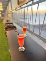 two cocktails sitting on a table near the ocean at Claridge Star Hotel in Ras al Khaimah