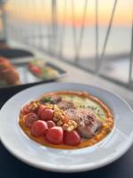 a plate of food with meat and beans on a table at Claridge Star Hotel in Ras al Khaimah