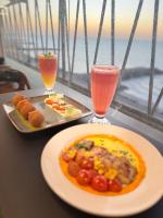 a table with a plate of food and two drinks at Claridge Star Hotel in Ras al Khaimah