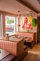 a restaurant with two tables and a window at Abitta Condado by IHG in San Juan