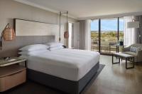 a bedroom with a large white bed and a balcony at Orlando World Center Marriott in Orlando