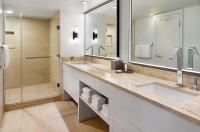 a bathroom with two sinks and a shower at Orlando World Center Marriott in Orlando