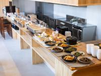 a long buffet line with bowls of food on it at APA Hotel Akabane Iwabuchi Ekimae in Tokyo