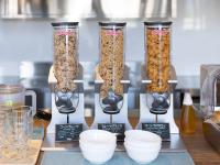 three tall glass vases filled with different types of cereal at APA Hotel Akabane Iwabuchi Ekimae in Tokyo