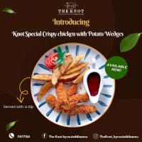 a plate of food with fried chicken and french fries at Long Beach Laamu Hotel in Gan