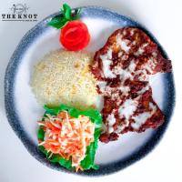 a plate of food with a sandwich and a tomato at Long Beach Laamu Hotel in Gan