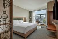 a hotel room with a bed and a desk at Courtyard by Marriott Berlin City Center in Berlin