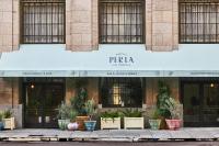 a facade of a building with potted plants on the sidewalk at Hotel Per La, Autograph Collection in Los Angeles