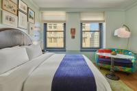 a bedroom with a large bed and a chair at Hotel Per La, Autograph Collection in Los Angeles