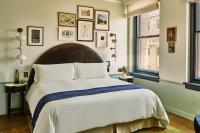 a bedroom with a large bed and some windows at Hotel Per La, Autograph Collection in Los Angeles