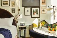 a bedroom with a bed and a table with a bowl of fruit at Hotel Per La, Autograph Collection in Los Angeles