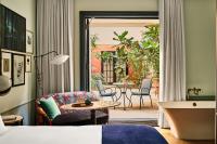a hotel room with a bed and a patio at Hotel Per La, Autograph Collection in Los Angeles