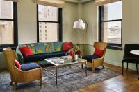 a living room with a couch and two chairs at Hotel Per La, Autograph Collection in Los Angeles