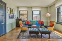 a living room with a blue couch and chairs at Hotel Per La, Autograph Collection in Los Angeles