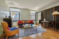 a living room with a couch and a table at Hotel Per La, Autograph Collection in Los Angeles