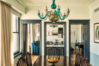a dining room with a table and a chandelier at Hotel Per La, Autograph Collection in Los Angeles