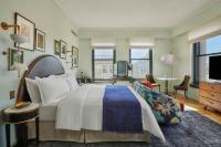 a bedroom with a large bed and a living room at Hotel Per La, Autograph Collection in Los Angeles