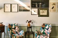a room with two chairs and a table and pictures at Hotel Per La, Autograph Collection in Los Angeles