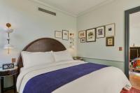 a bedroom with a large bed with a blue blanket at Hotel Per La, Autograph Collection in Los Angeles